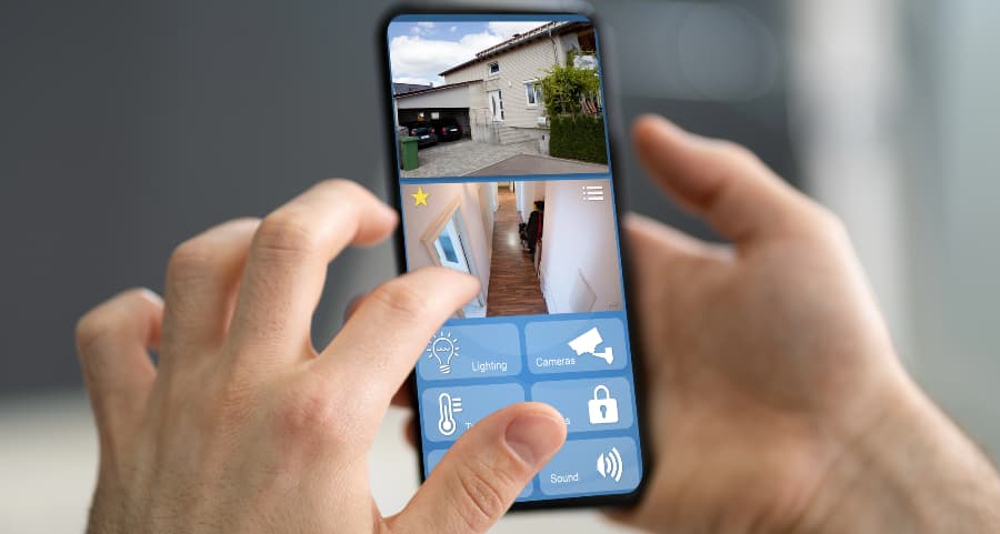Homeowner examining surveillance camera footage on a mobile device
